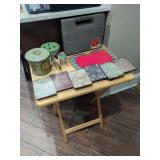 Assorted Home Decor and Collectibles Collection Including Metal Tin, Glass Flower Frog, and Signs