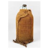 Antique Glass Water Jug Wrapped In Burlap