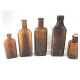 5 Amber Embossed Antique Bottles
