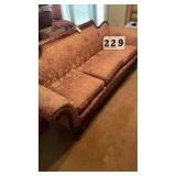vintage Empire-style sofa features an ornate