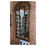 ornate arched wall mirror features a striking