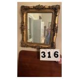 Framed wall mirror. 26 inches x 29 inches.