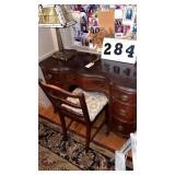 Wood desk, chair and lamp.