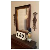 Framed wall mirror, candle with stand and wall