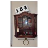 wooden wall-mounted curio cabinet features an