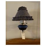 Oil lamp hangs on wall.