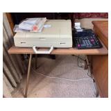 Typewriter and Calculator on Table