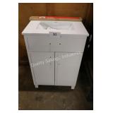 24" white vanity w top (back leg broken)