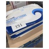 four cases of toilet seat covers