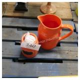 orange pitcher and container
