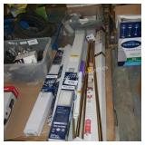 lot of blinds and drapery rods