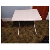 Small white plastic and metal folding table