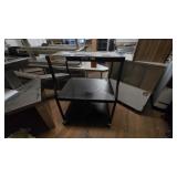 Black metal utility/serving cart with shelves.