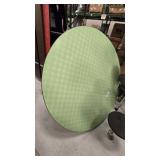 Round green-top table with pedestal base.