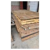Assorted plywood sheets, wood panels and lumber.