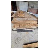 Assorted plywood sheets, wood panels and lumber.