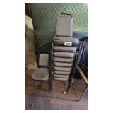 Stack of padded metal-frame chairs.