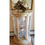 Rounded glass curio cabinet with floral