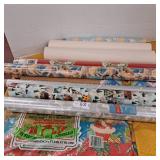 Various rolls of Christmas wrapping paper,