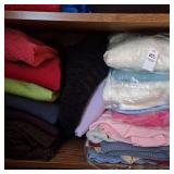 Shelf of Variety ladies sweaters various sizes