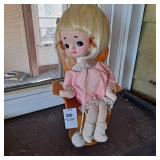 Vintage musical doll, specifically a "big eye" or