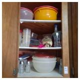 Three shelves of various storage containers,