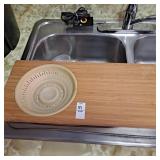 over-the-sink cutting board with a collapsible
