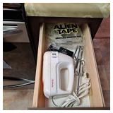 Sunbeam hand mixer, battery tester, alien tape