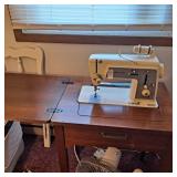 Singer touch and sew machine in cabinet