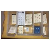 Tiny stud earrings in plastic organizer box