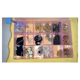 Vintage earrings & necklaces in plastic storage