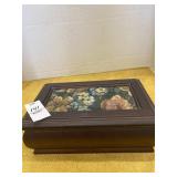 Jewelry box with tapestry material on lid.
