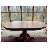 Oval wooden pedestal dining table with leaves