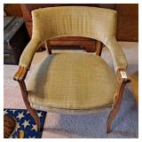 Vintage upholstered armchair with a wooden frame.