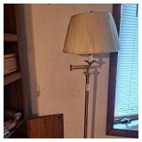 Brushed nickel swing arm floor lamp with a white
