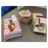 Three vintage perfume bottles and dusting powder