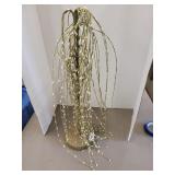 Wiping willow tree on wooden stand