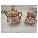 Vintage cream & sugar creamer has hair line crack