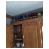 Misc glassware in cupboard and on top shelf above