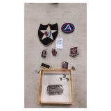Assorted pins, patches, and a dog tag