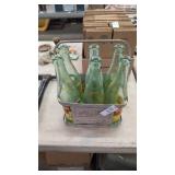 6 r.c cola bottles in metal holder.