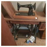 Antique Singer treadle sewing machine in a wooden