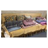 Lot of Rugs and Pillows on Couch