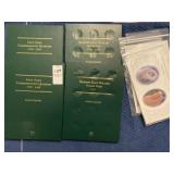 Two commemorative empty quarter books, two