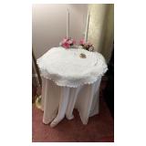Round End Table with Doily and Light Candles