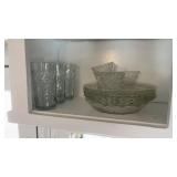 Shelf of glassware, plates, drinking glasses,