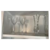Shelf with wine glasses and flower vases