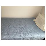 Twin bed with bedding