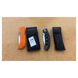 Two Frost Knives Orange and Black W Cases