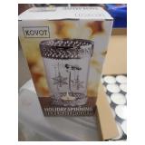 Holiday spinning tea light holder